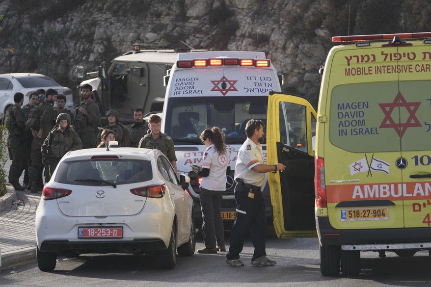 Israeli soldiers and emergency personnel gather near ambulances following a shooting attack near Yehuda Junction, near Hebron, in the occupied West Bank, Friday, Oct. 23, 2026. (AP Photo/Mahmoud Illean)