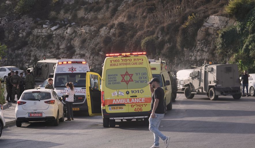 Israeli soldiers and emergency personnel gather near ambulances following a shooting attack near Yehuda Junction, near Hebron, in the occupied West Bank, Friday, Oct. 23, 2026. (AP Photo/Mahmoud Illean)