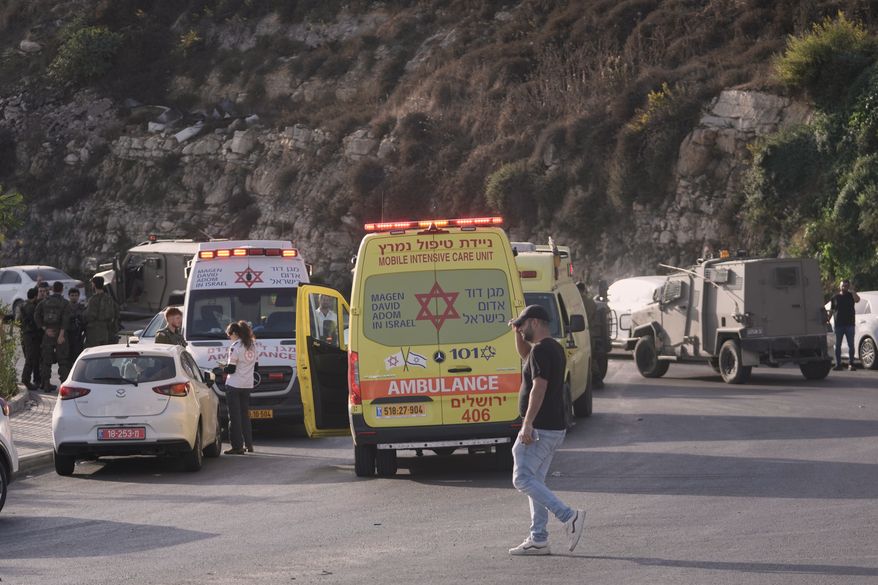 Israeli soldiers and emergency personnel gather near ambulances following a shooting attack near Yehuda Junction, near Hebron, in the occupied West Bank, Friday, Oct. 23, 2026. (AP Photo/Mahmoud Illean)