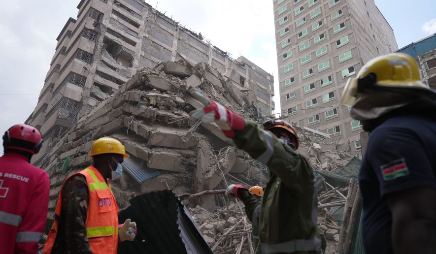 Security forces and civil defense work after a multi-story building collapsed in Nairobi, Kenya, Friday, Oct. 23, 2026. (AP Photo/Brian Inganga)