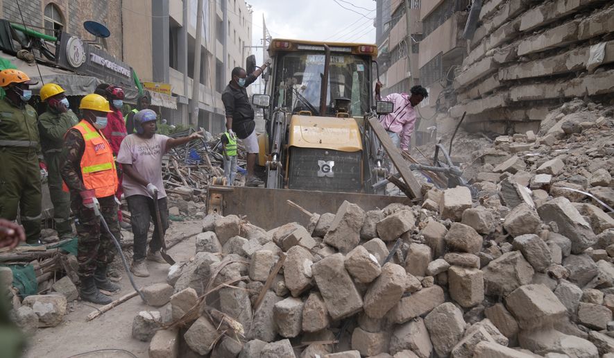 Rescue workers work at the scene of a multi-story building that collapsed in Nairobi, Kenya, Friday, Oct. 23, 2026. (AP Photo/Brian Inganga)