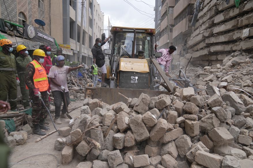 Rescue workers work at the scene of a multi-story building that collapsed in Nairobi, Kenya, Friday, Oct. 23, 2026. (AP Photo/Brian Inganga)