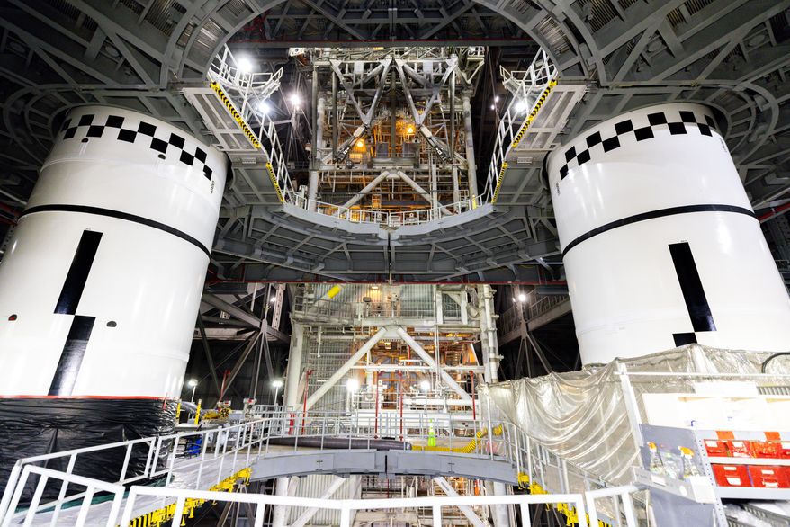 In this photo provided by NASA, the final left and right forward solid rocket booster motor segments for Artemis III are integrated onto the mobile launcher for the SLS (Space Launch System) rocket on Thursday, Sept. 24, 2026 at NASA's Kennedy Space Center in Florida. (Frank Michaux/NASA via AP)