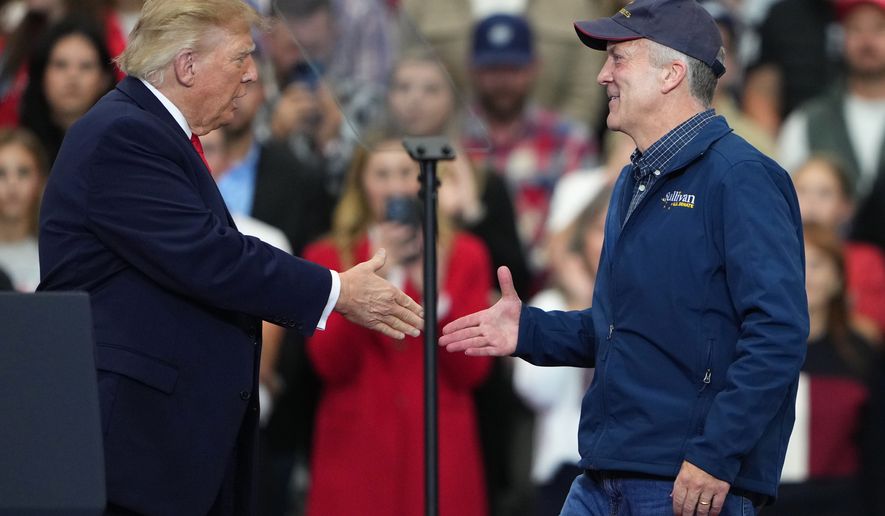 President Donald Trump greets Sen. Dan Sullivan, R-Alaska, at a campaign rally at the Curtis D. Menard Memorial Sports Center, Tuesday, Oct. 13, 2026, in Wasilla, Alaska. (AP Photo/Lindsey Wasson)