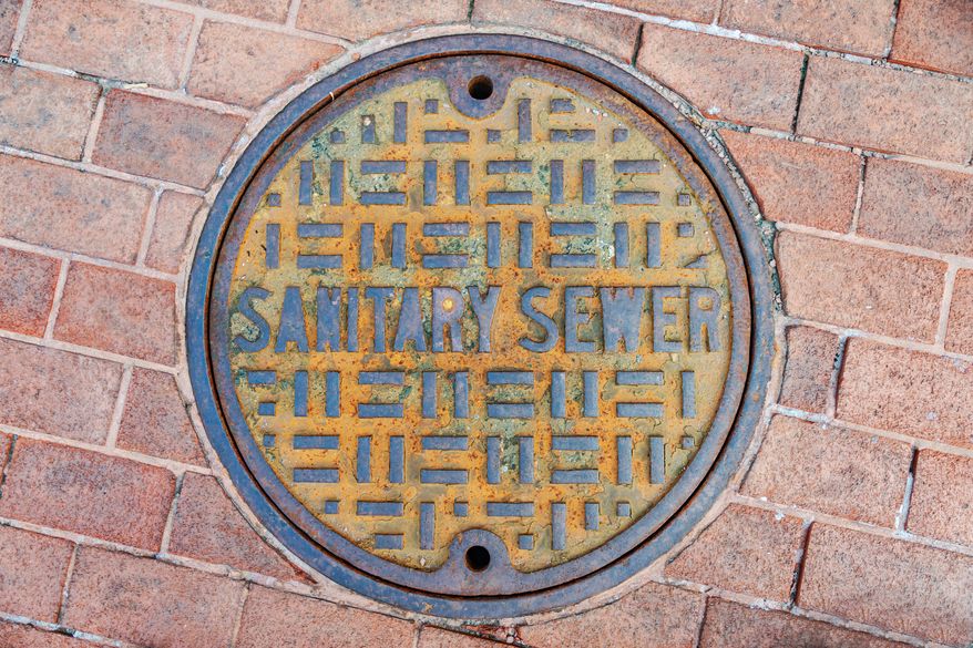 A manhole cover of a sewer in Baltimore. File photo credit: SUNGMOON HAN via Shutterstock.