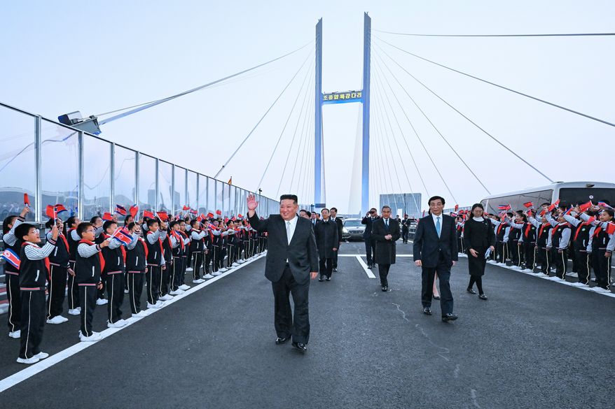 In this photo released by Xinhua News Agency, North Korean leader Kim Jong Un, left, is accompanied by Wang Huning, a member of the Standing Committee of China's Communist Party, second right, and Chinese Foreign Minister Wang Yi, third right, during a see-off ceremony at the new Yalu River Bridge, that connects the two countries, after Kim's visit to Dandong, northeast China's Liaoning Province on Saturday, Oct. 24, 2026. (Rao Aimin/Xinhua via AP)