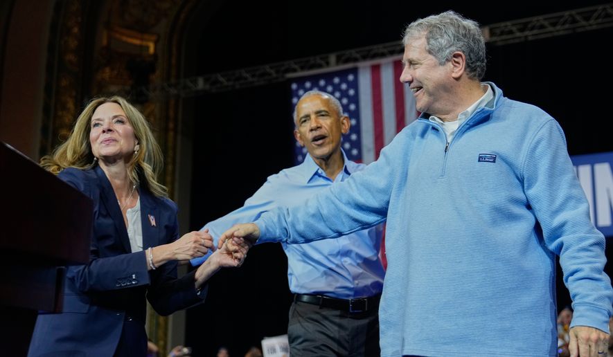 From left, Democratic Ohio gubernatorial candidate Amy Acton, left, former President Barack Obama, center, and Ohio Democratic candidate for U.S. Senate Sherrod Brown, right, attend a campaign rally Saturday, Oct. 24, 2026, in Cleveland. (AP Photo/Sue Ogrocki)