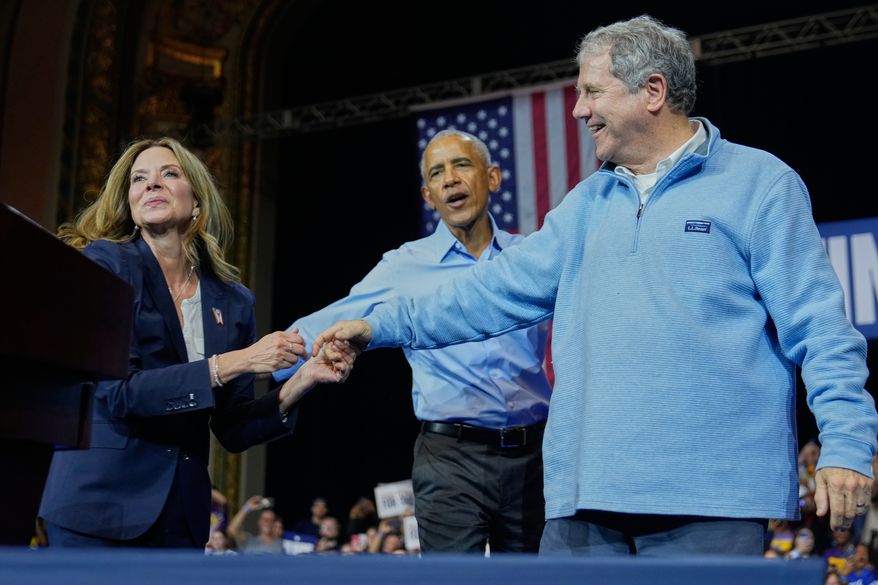From left, Democratic Ohio gubernatorial candidate Amy Acton, left, former President Barack Obama, center, and Ohio Democratic candidate for U.S. Senate Sherrod Brown, right, attend a campaign rally Saturday, Oct. 24, 2026, in Cleveland. (AP Photo/Sue Ogrocki)