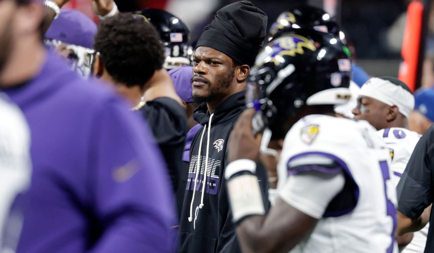 Baltimore Ravens quarterback Lamar Jackson, center, watches from the sideline during the second half of an NFL football game against the Atlanta Falcons, Sunday, Oct. 11, 2026, in Atlanta. (AP Photo/Erik S. Lesser)