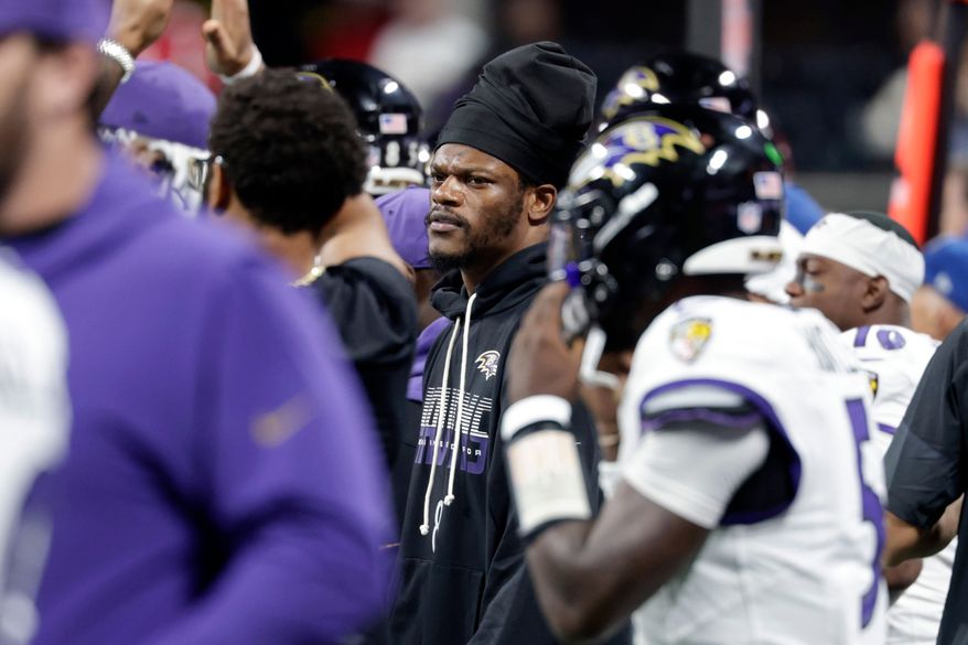 Baltimore Ravens quarterback Lamar Jackson, center, watches from the sideline during the second half of an NFL football game against the Atlanta Falcons, Sunday, Oct. 11, 2026, in Atlanta. (AP Photo/Erik S. Lesser)