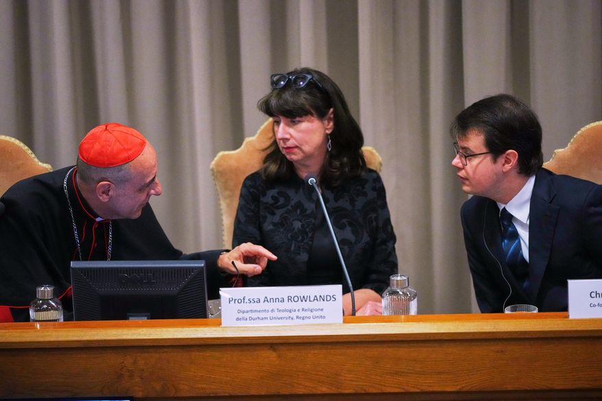 From left, Cardinal Víctor Manuel Fernández, prefect of the Dicastery for the Doctrine of the Faith, talks with theologian Anna Rowlands, and Anthropic co-founder Christopher Olah during the presentation of Pope Leo XIV's first encyclical, "Magnifica humanitas: On Safeguarding the Human Person in the Time of Artificial Intelligence," at the Vatican, May 25, 2026. (AP Photo/Alessandra Tarantino, File)