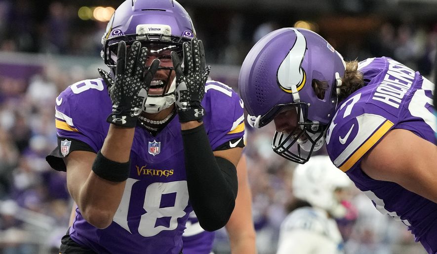 Minnesota Vikings wide receiver Justin Jefferson (18) celebrates after a touchdown by tight end T.J. Hockenson, right, during the second half of an NFL football game against the Indianapolis Colts in Minneapolis, Sunday, Oct. 25, 2026. (AP Photo/Ellen Schmidt)