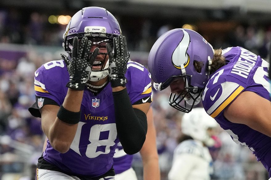 Minnesota Vikings wide receiver Justin Jefferson (18) celebrates after a touchdown by tight end T.J. Hockenson, right, during the second half of an NFL football game against the Indianapolis Colts in Minneapolis, Sunday, Oct. 25, 2026. (AP Photo/Ellen Schmidt)