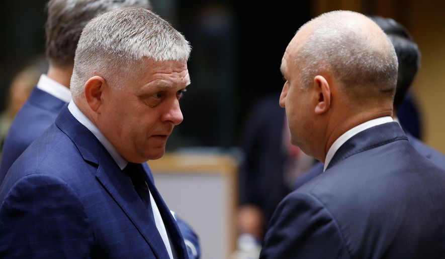 Slovakia's Prime Minister Robert Fico, left, speaks with Bulgaria's Prime Minister Rumen Radev during a round table meeting at the EU summit in Brussels, Friday, Oct. 16, 2026. (AP Photo/Geert Vanden Wijngaert)