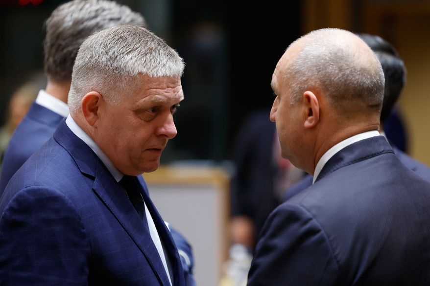 Slovakia's Prime Minister Robert Fico, left, speaks with Bulgaria's Prime Minister Rumen Radev during a round table meeting at the EU summit in Brussels, Friday, Oct. 16, 2026. (AP Photo/Geert Vanden Wijngaert)