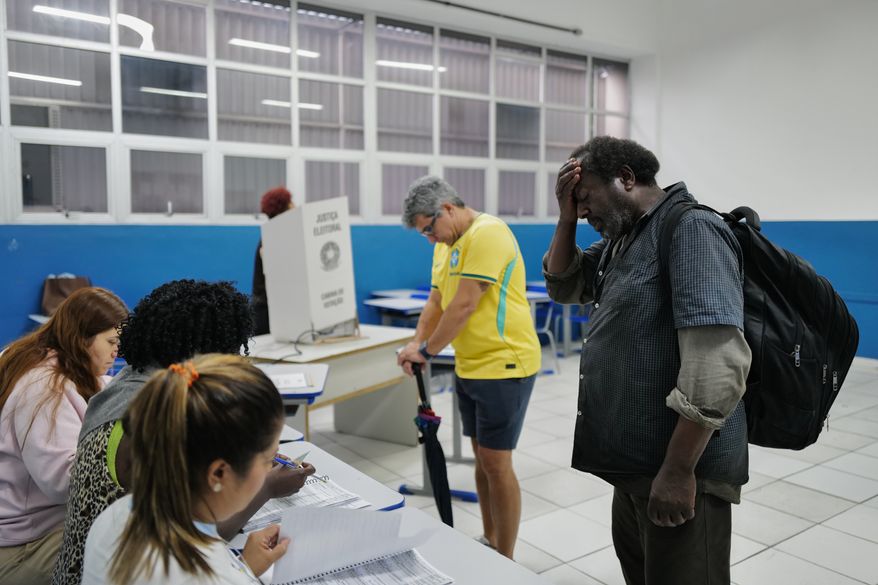 Voters wait to cast their ballots during a presidential runoff in Rio de Janeiro, Sunday, Oct. 25, 2026. (AP Photo/Lucas Landau)