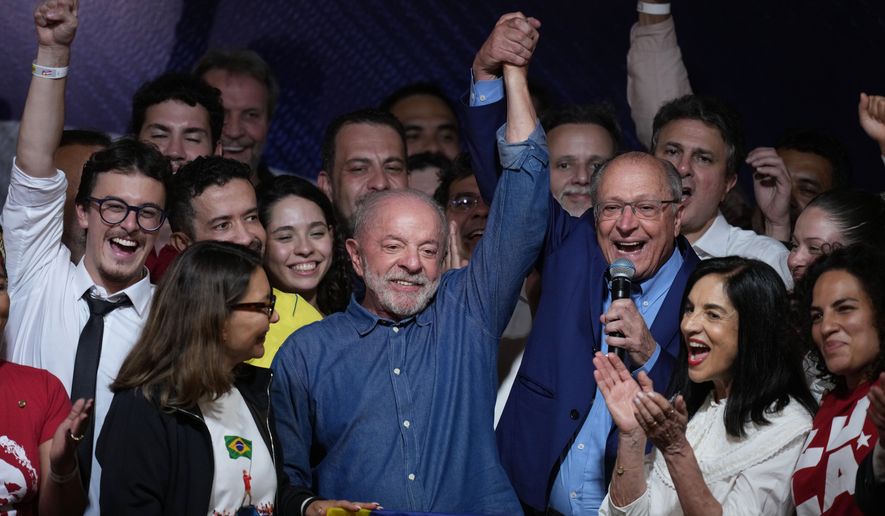 President Luiz Inacio Lula da Silva celebrates with his running mate Geraldo Alckmin after winning a fourth term in the presidential runoff in , Brazil, Sunday, Oct. 25, 2026.(AP Photo/Andre Penner)