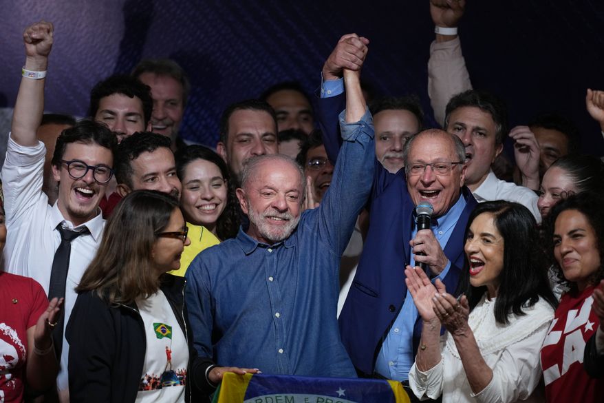 President Luiz Inacio Lula da Silva celebrates with his running mate Geraldo Alckmin after winning a fourth term in the presidential runoff in , Brazil, Sunday, Oct. 25, 2026.(AP Photo/Andre Penner)