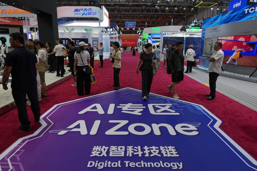 Visitors tour the exhibition booths operated with Artificial Intelligence (AI) at the China International Supply Chain Expo in Beijing on June 25, 2026. (AP Photo/Andy Wong, File)