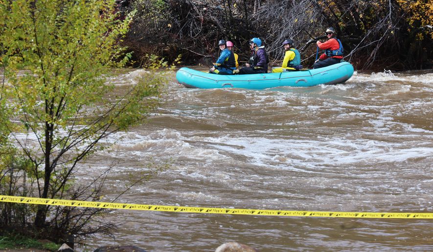 Rafters make their way down a closed Animas River Saturday, Oct. 24, 2026, in Durango, Colo. (Jerry McBride/The Durango Herald via AP)