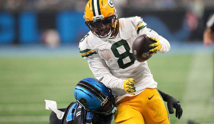 Green Bay Packers running back Josh Jacobs (8) breaks a tackle by Detroit Lions cornerback Keith Abney II (6) during a touchdown reception in the second half of an NFL football game, Sunday, Oct. 25, 2026, in Detroit. (AP Photo/Paul Sancya)