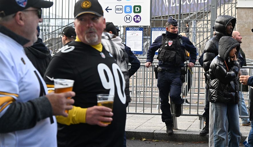 A police officer stands outside the Stade de France stadium before the start of the NFL football game between Pittsburgh Steelers and New Orleans Saints in Saint-Denis, outside Paris, Sunday, Oct. 25, 2026. (AP Photo/Emma Da Silva)