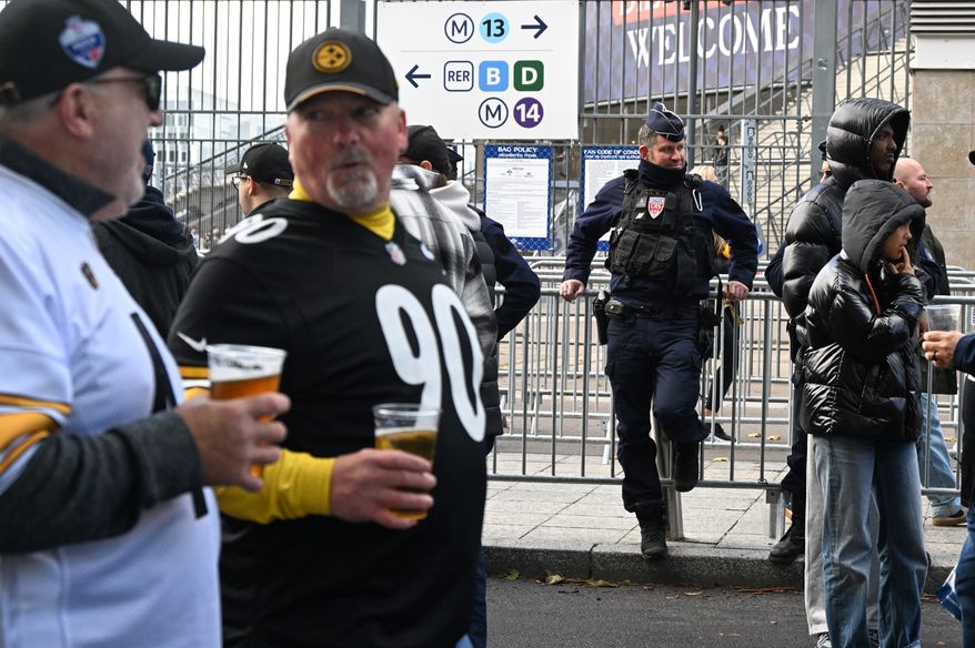A police officer stands outside the Stade de France stadium before the start of the NFL football game between Pittsburgh Steelers and New Orleans Saints in Saint-Denis, outside Paris, Sunday, Oct. 25, 2026. (AP Photo/Emma Da Silva)