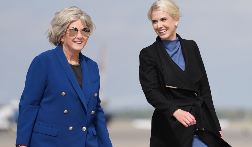 White House chief of staff Susie Wiles and White House aide Natalie Harp walk to board Air Force One, Friday, Oct. 16, 2026, at Joint Base Andrews, Md. (AP Photo/Mark Schiefelbein)
