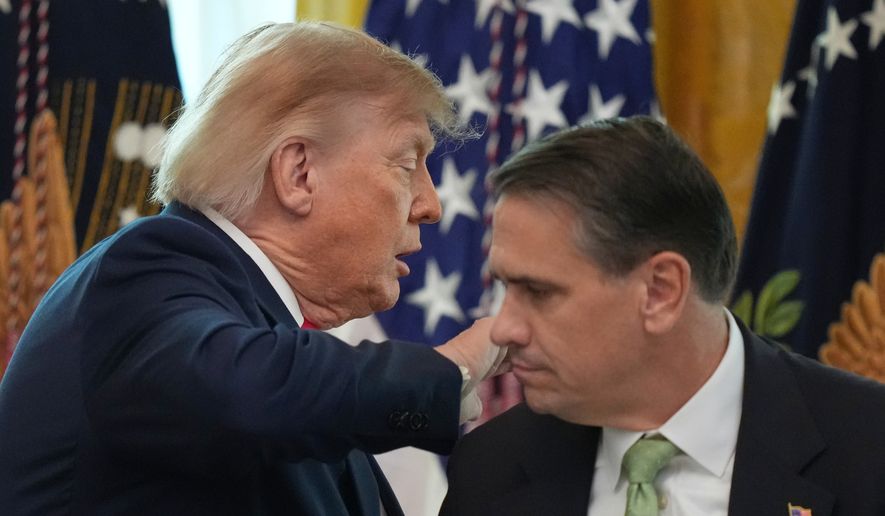 President Donald Trump walks past Attorney General Todd Blanche after speaking at a roundtable event in the East Room of the White House, Wednesday, Oct. 21, 2026, in Washington. (AP Photo/Alex Brandon)