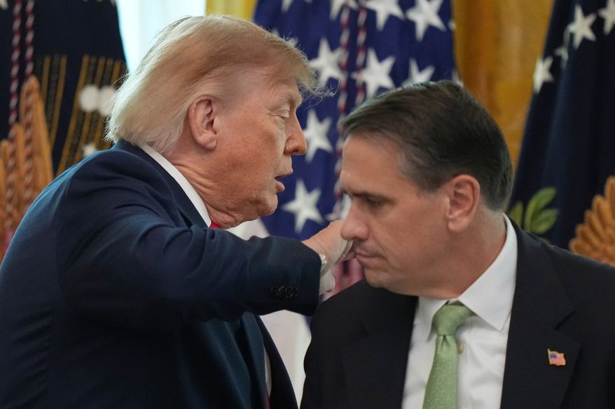 President Donald Trump walks past Attorney General Todd Blanche after speaking at a roundtable event in the East Room of the White House, Wednesday, Oct. 21, 2026, in Washington. (AP Photo/Alex Brandon)