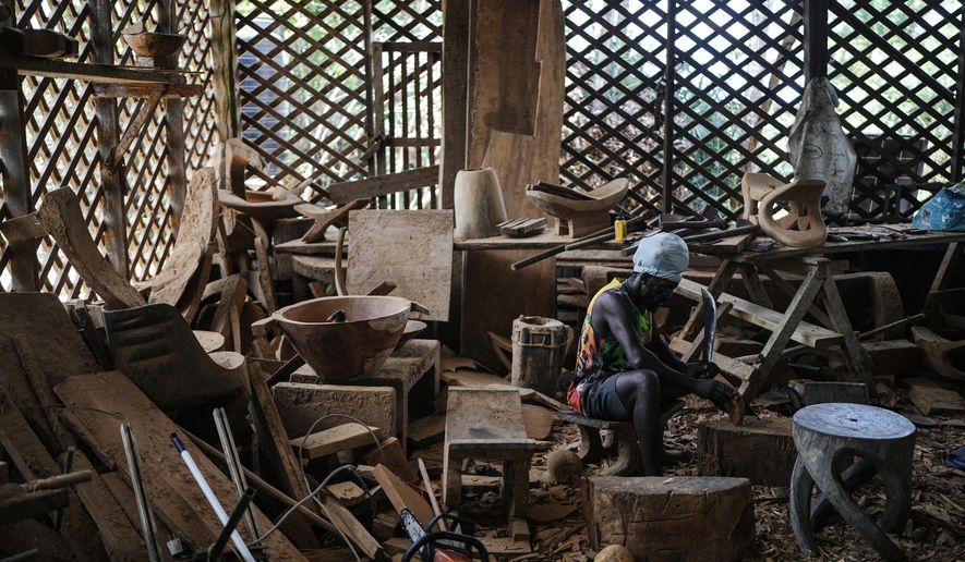 Josasath Liefde, a wood carver, works in his workshop in Pikienslee, Suriname, Monday, Sept. 28, 2026. (AP Photo/Ivan Valencia)