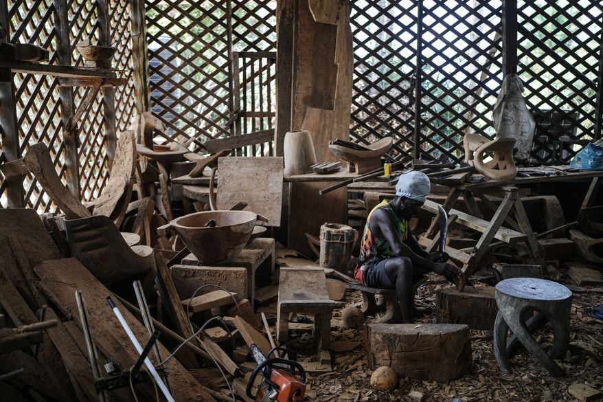 Josasath Liefde, a wood carver, works in his workshop in Pikienslee, Suriname, Monday, Sept. 28, 2026. (AP Photo/Ivan Valencia)