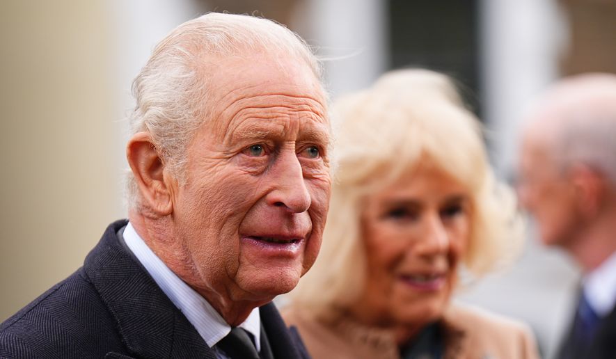 Britain's King Charles and Queen Camilla attend a commemoration event at Aberfan Memorial Garden, where survivors, bereaved families and community members pay tribute to the 144 people killed in the Aberfan disaster 60 years ago, in Aberfan, Wales, Wednesday, Oct. 21, 2026. (Aaron Chown/PA via AP, Pool)