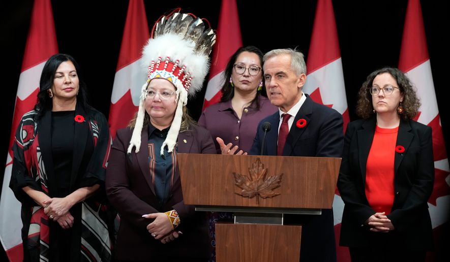Minister of Northern and Arctic Affairs Rebecca Chartrand, left to right, AFN National Chief Cindy Woodhouse Nepinak, Indigenous Services Minister Mandy Gull-Masty and Crown-Indigenous Relations Minister Rebecca Alty, right, look on as Canada Prime Minister Mark Carney speaks with media following the First Nations and First Ministers' meeting in Ottawa, Monday, Oct. 26, 2026. (Adrian Wyld/The Canadian Press via AP)