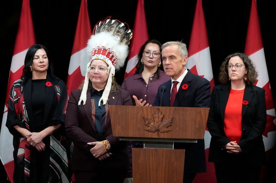 Minister of Northern and Arctic Affairs Rebecca Chartrand, left to right, AFN National Chief Cindy Woodhouse Nepinak, Indigenous Services Minister Mandy Gull-Masty and Crown-Indigenous Relations Minister Rebecca Alty, right, look on as Canada Prime Minister Mark Carney speaks with media following the First Nations and First Ministers' meeting in Ottawa, Monday, Oct. 26, 2026. (Adrian Wyld/The Canadian Press via AP)