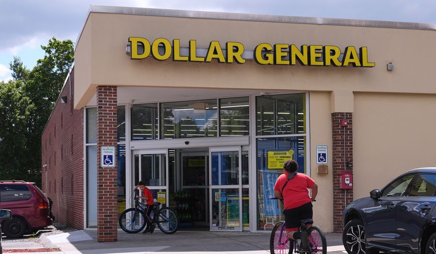 Children ride their bicycles to the Dollar General store, Aug. 21, 2025, in Nashua, N.H. (AP Photo/Charles Krupa, File)