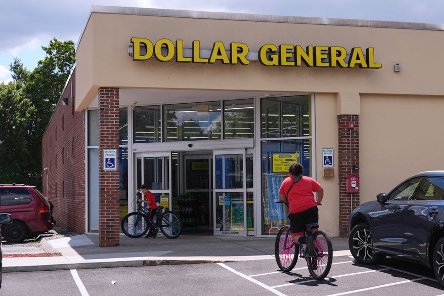 Children ride their bicycles to the Dollar General store, Aug. 21, 2025, in Nashua, N.H. (AP Photo/Charles Krupa, File)