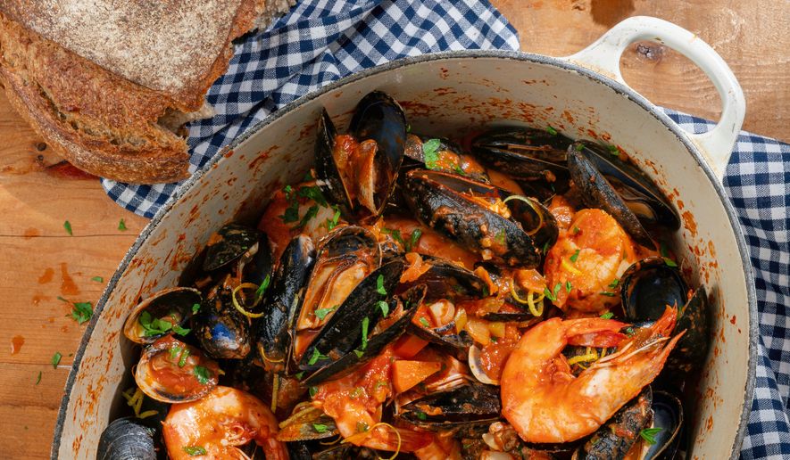 This image released by Voracious shows a recipe for a kimchi seafood pot from the cookbook "Hand Taste" by Esther Choi. (Janice Chung/Voracious via AP)