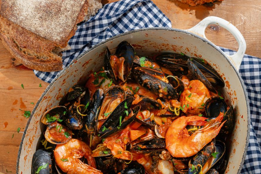 This image released by Voracious shows a recipe for a kimchi seafood pot from the cookbook "Hand Taste" by Esther Choi. (Janice Chung/Voracious via AP)