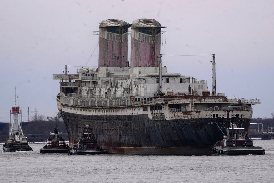 The SS United States is towed down the Delaware River between Pennsylvania and New Jersey, from Philadelphia, Wednesday, Feb. 19, 2025. (AP Photo/Matt Rourke, File)