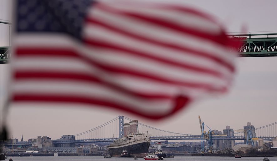 The SS United States is towed down the Delaware River between Pennsylvania and New Jersey, from Philadelphia, on Feb. 19, 2025. (AP Photo/Matt Rourke, File)