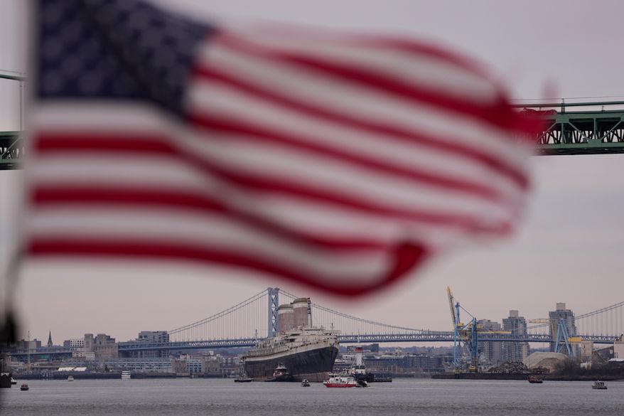 The SS United States is towed down the Delaware River between Pennsylvania and New Jersey, from Philadelphia, on Feb. 19, 2025. (AP Photo/Matt Rourke, File)