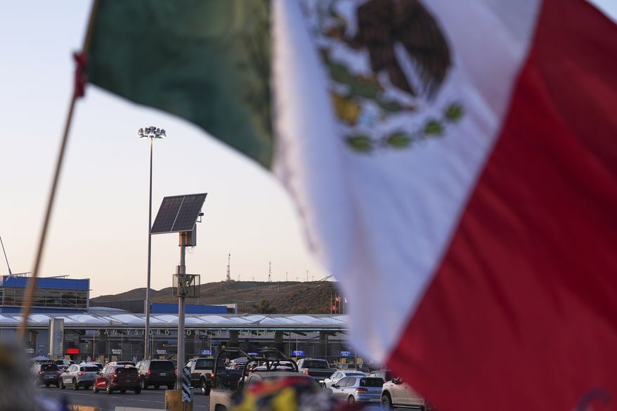 Vehicles wait at a U.S.-Mexico border crossing at the San Ysidro Port of Entry in Tijuana, Mexico, on Tuesday, March 18, 2025. (AP Photo/Gregory Bull, File)