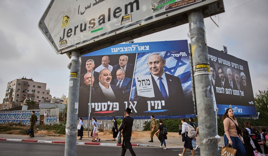 People walk past a Likud party campaign billboard featuring Israeli Prime Minister Benjamin Netanyahu alongside opposition party leaders and bearing the Hebrew slogan "Right or Palestine," ahead of Israel's general election, in Beni Brak, Israel, Sunday, Oct. 25, 2026. (AP Photo/Oded Balilty)