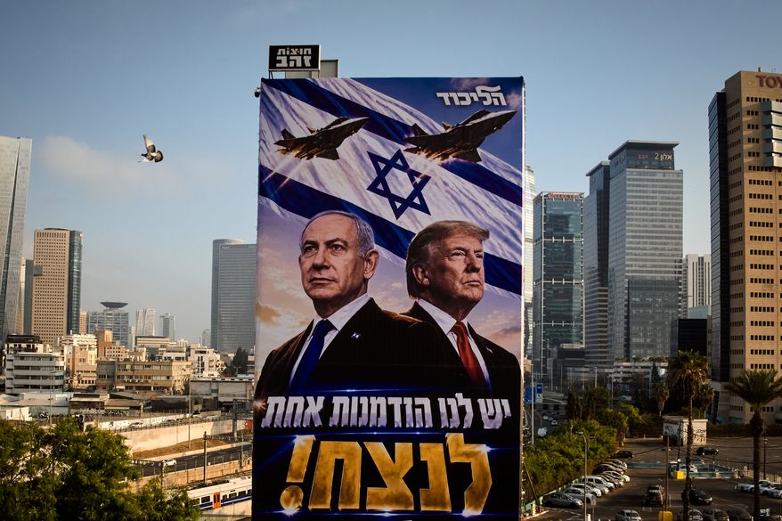 A pigeon flies past a Likud Party campaign billboard featuring U.S. President Donald Trump and Israeli Prime Minister Benjamin Netanyahu, with a Hebrew message reading, "We have one opportunity to win," in Tel Aviv, Israel, Monday, Oct. 26, 2026. (AP Photo/Oded Balilty)