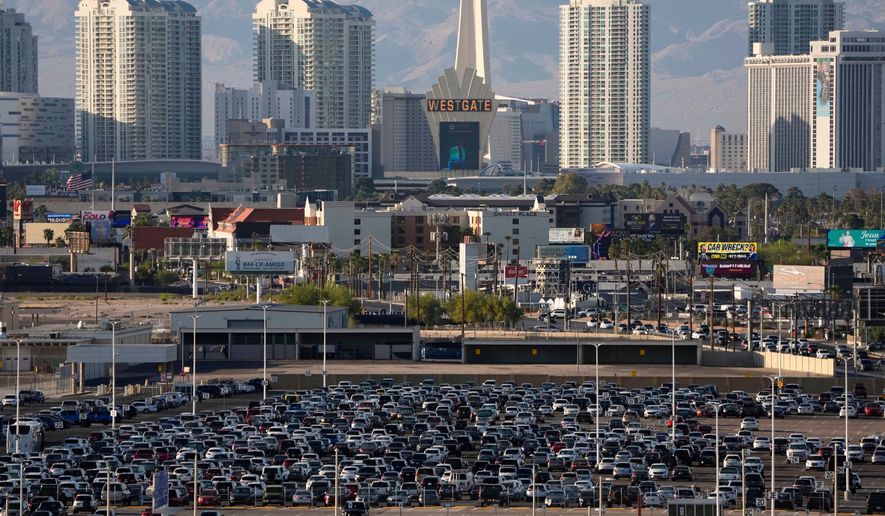 Cars fill a lot at Harry Reid International Airport near the Las Vegas Strip, April 9, 2025, in Las Vegas. (AP Photo/John Locher, File)