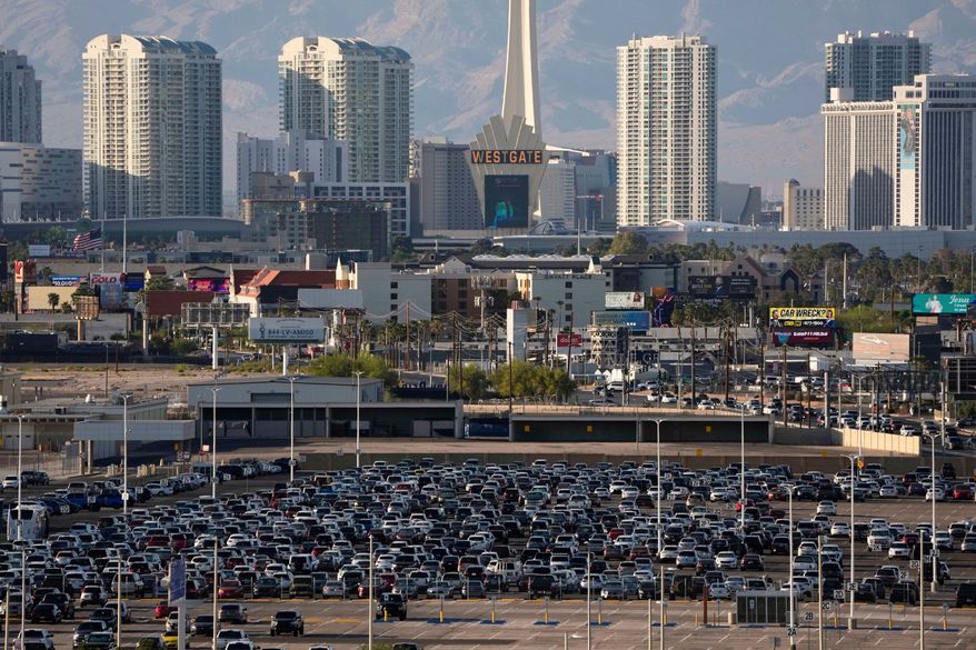 Cars fill a lot at Harry Reid International Airport near the Las Vegas Strip, April 9, 2025, in Las Vegas. (AP Photo/John Locher, File)