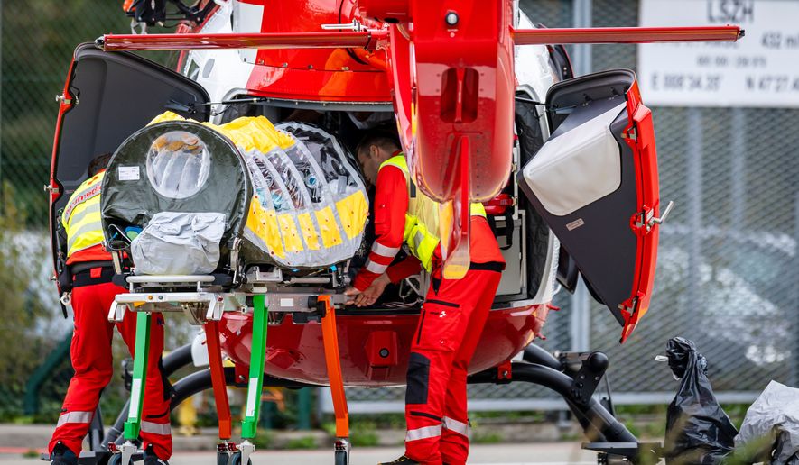A patient is being transferred in a isolation unit from a rescue aircraft to a rescue helicopter of Swiss Air Rescue at Zurich Airport on Monday, Oct. 26, 2026, in Zurich, Switzerland. (Michael Buholzer/Keystone via AP)