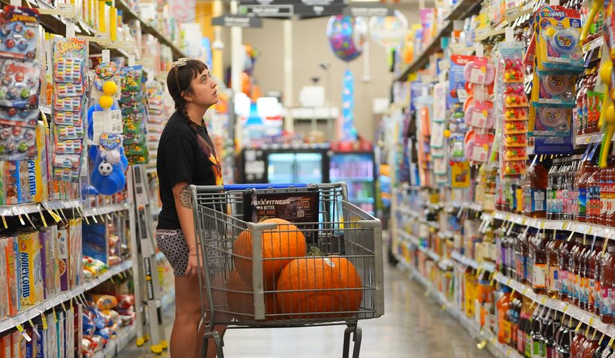 A shopper looks at items in an aisle at a grocery store in Fort Worth, Texas, Wednesday, Oct. 7, 2026. (AP Photo/LM Otero)