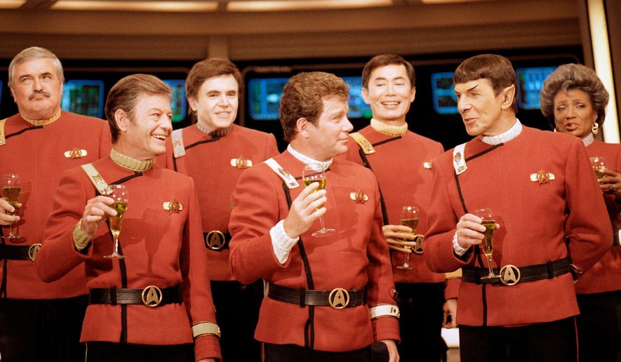 Members of the "Star Trek" crew, from left, James Doohan, DeForest Kelley, Walter Koenig, William Shatner, George Takei, Leonard Nimoy, and Nichelle Nichols, toast the newest "Star Trek" film at Paramount Studios on Dec. 28, 1988. (AP Photo/Bob Galbraith, File)